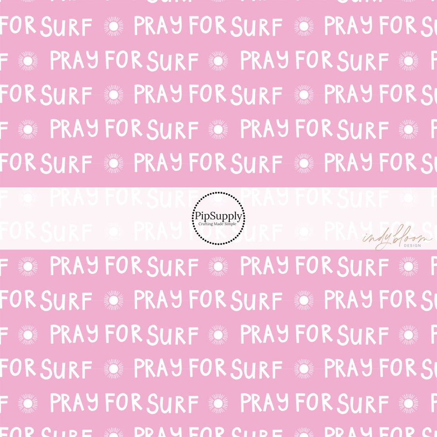 Pink fabric by the yard with suns and the phrase "Pray For Surf"