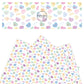 Pastel candy hearts on white faux leather sheets