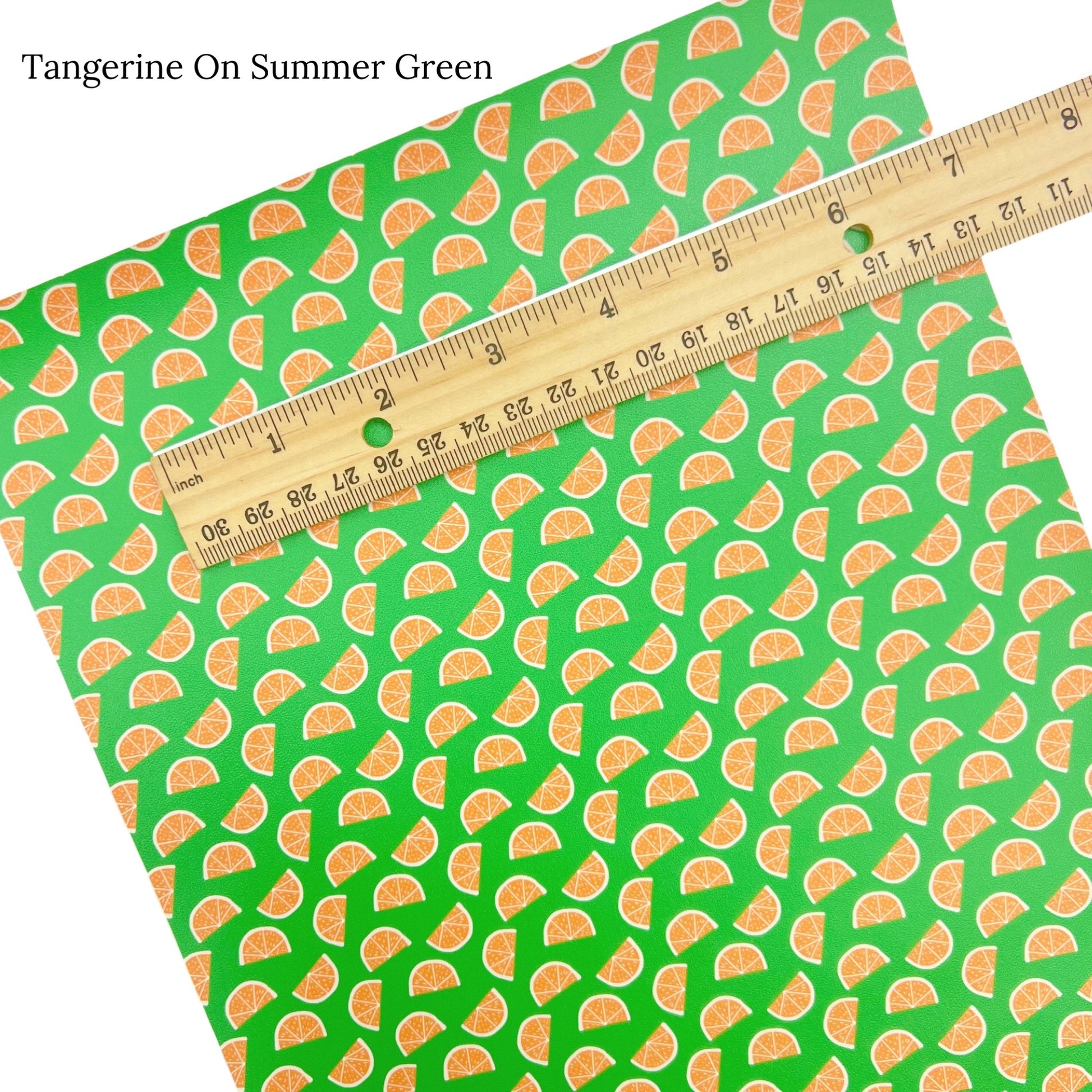 Summer fruit on bright green faux leather sheet.