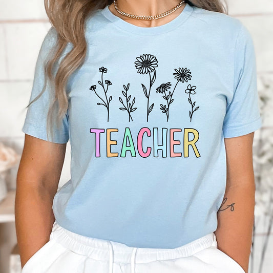 Iron on heat transfer  with wildflowers and the word "Teacher" in pastel colors.