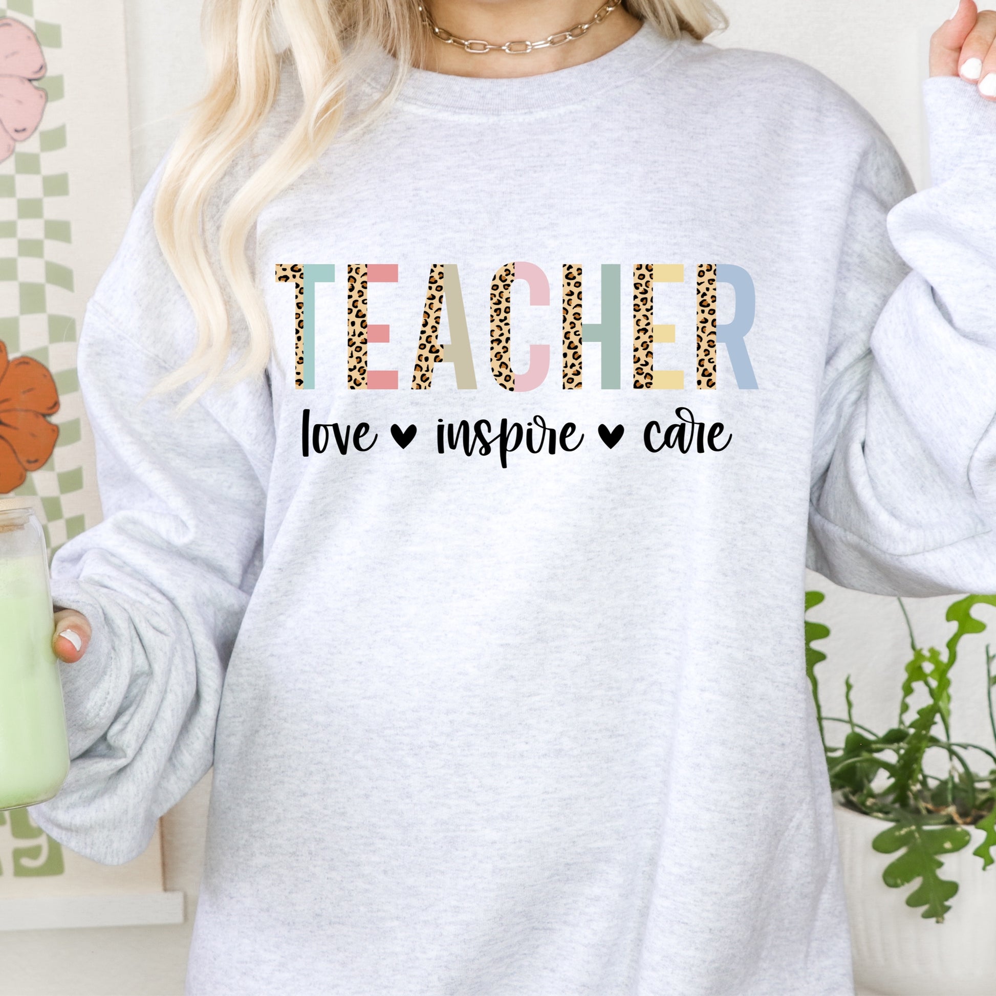 Iron on heat transfer with the words "love", "inspire", and "care", as well as the word "Teacher" with a leopard print design.