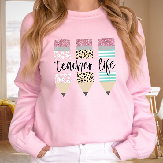 Floral, leopard print, and striped pencils with the word "Teacher" iron on heat transfer.