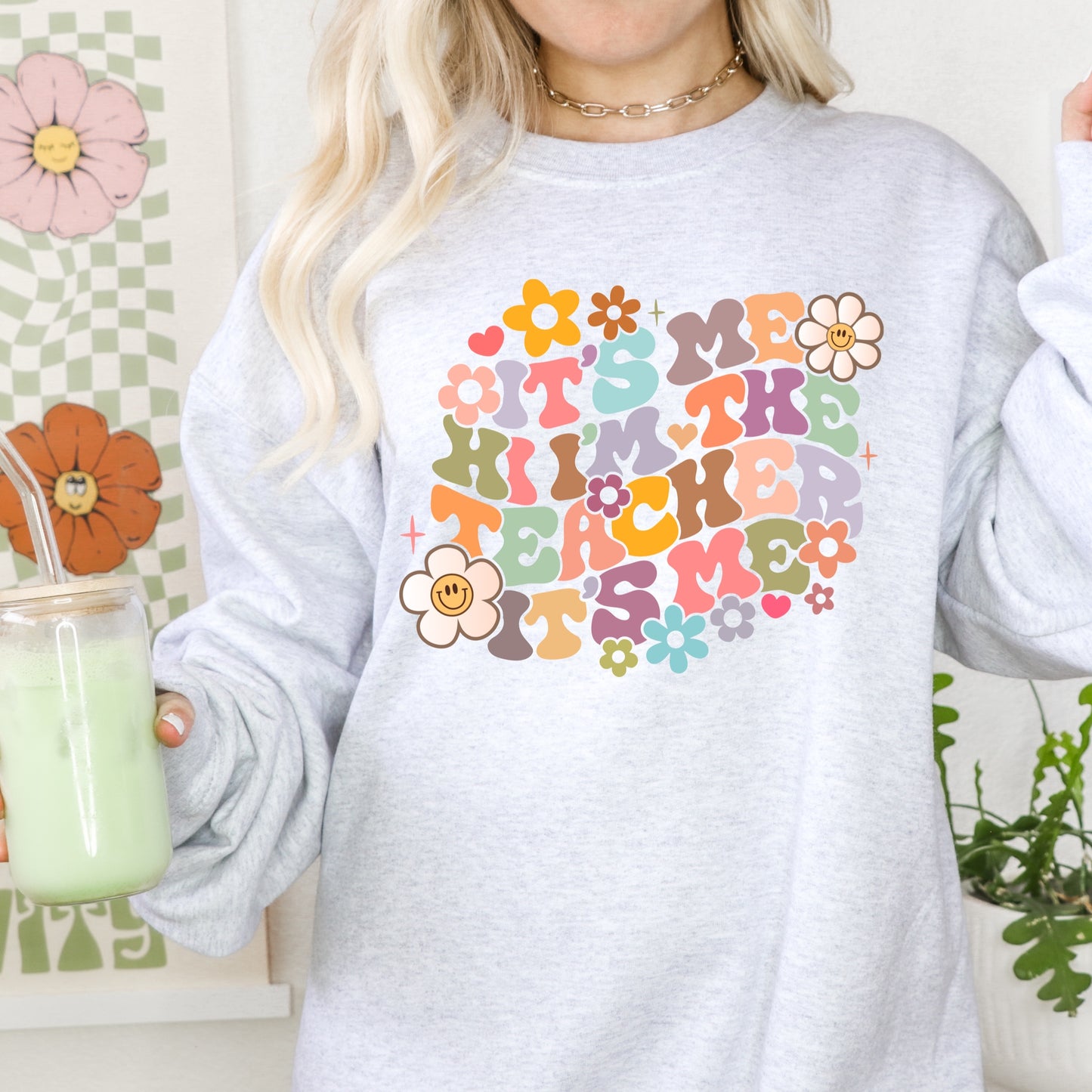 Multi-colored floral daisies and the phrase "It's Me Hi I'm the Teacher It's Me" iron on heat transfer.