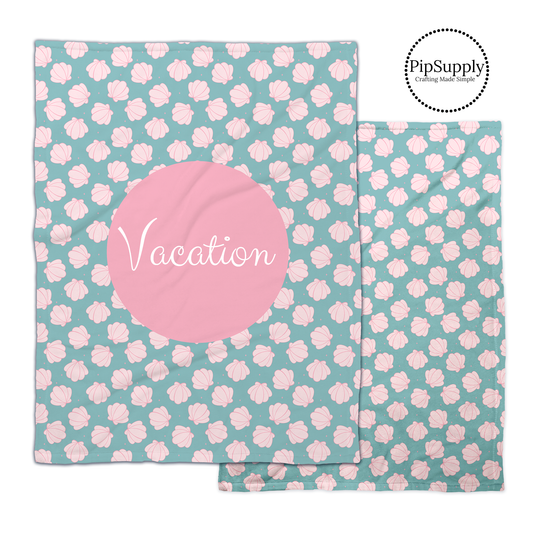 Tropical aqua and pink seashell pattern blanket with white customizable text on pink center.