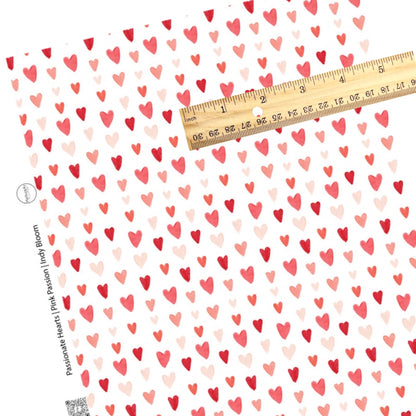 scattered red and pink hearts on a white faux leather sheet