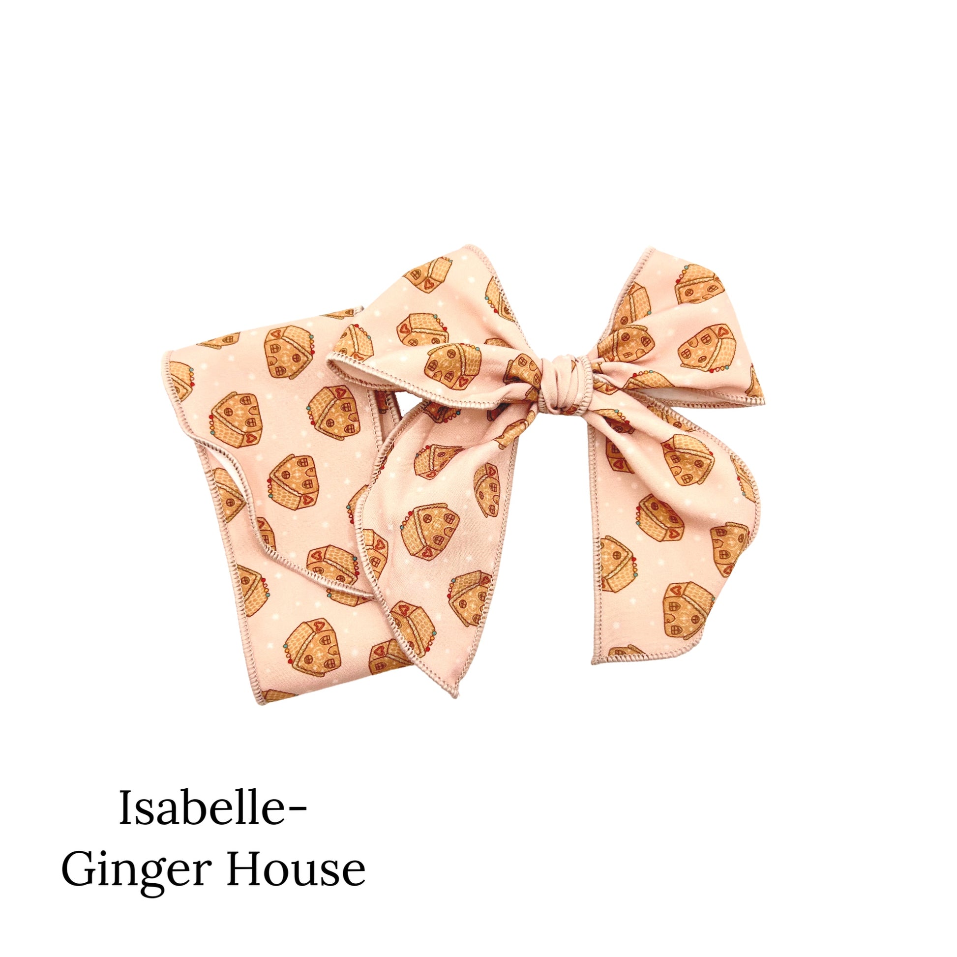 Cream colored christmas bow decorated with gingerbread houses
