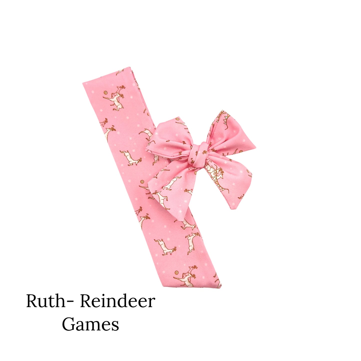 Pink christmas bow decorated with prancing reindeer