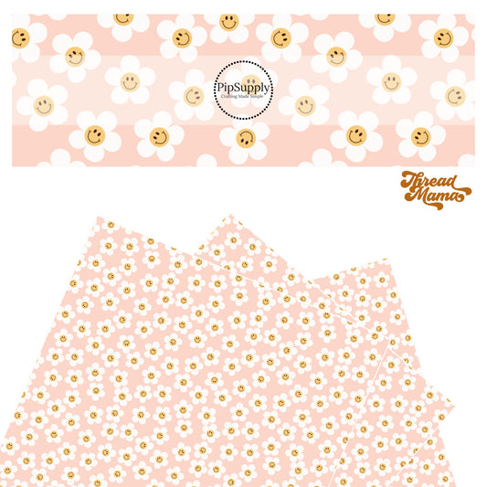 White scattered daisy with orange smiley face center on a pink faux leather sheet