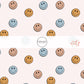 Blue, mustard, and copper smiley faces on cream fabric by the yard