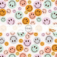 White fabric by the yard with orange, pink, blue, purple, and aqua smiley faces