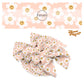 Scattered white daisies with orange smiley faces on pink bow strips