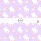 White Easter bunny print with floral designs on purple fabric by the yard.