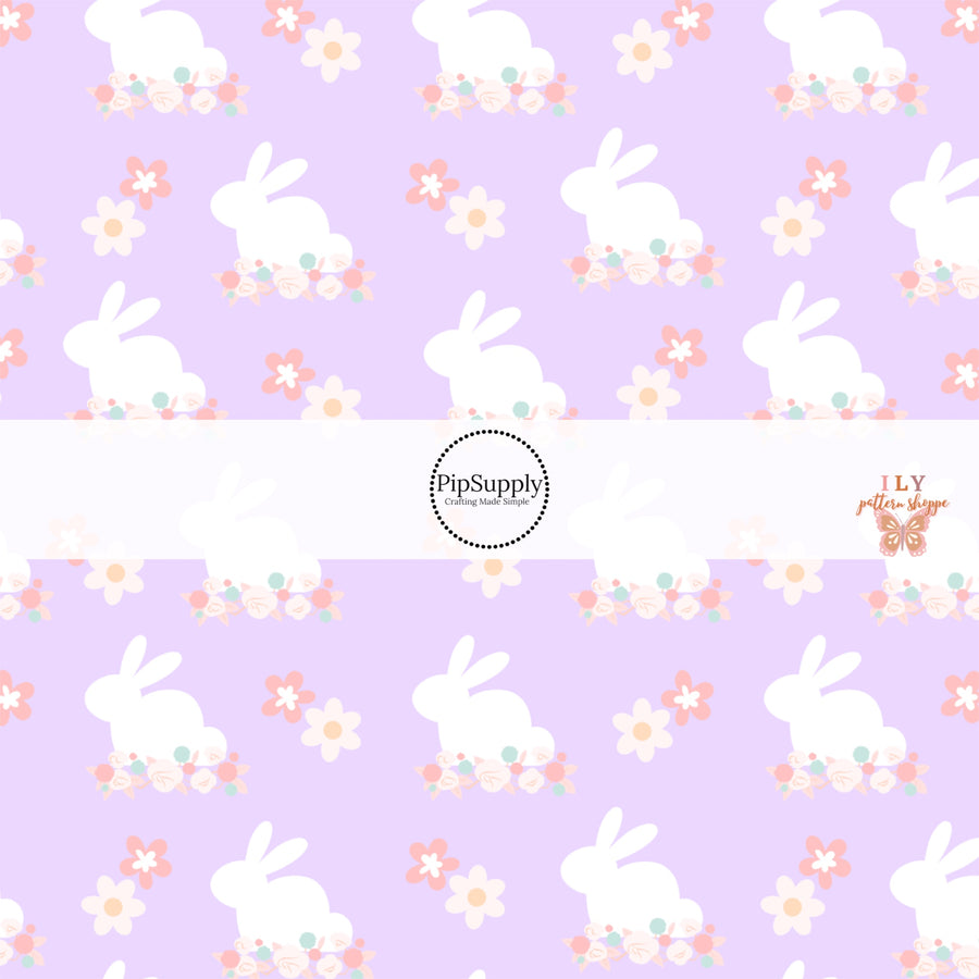 White Easter bunny print with floral designs on purple fabric by the yard.