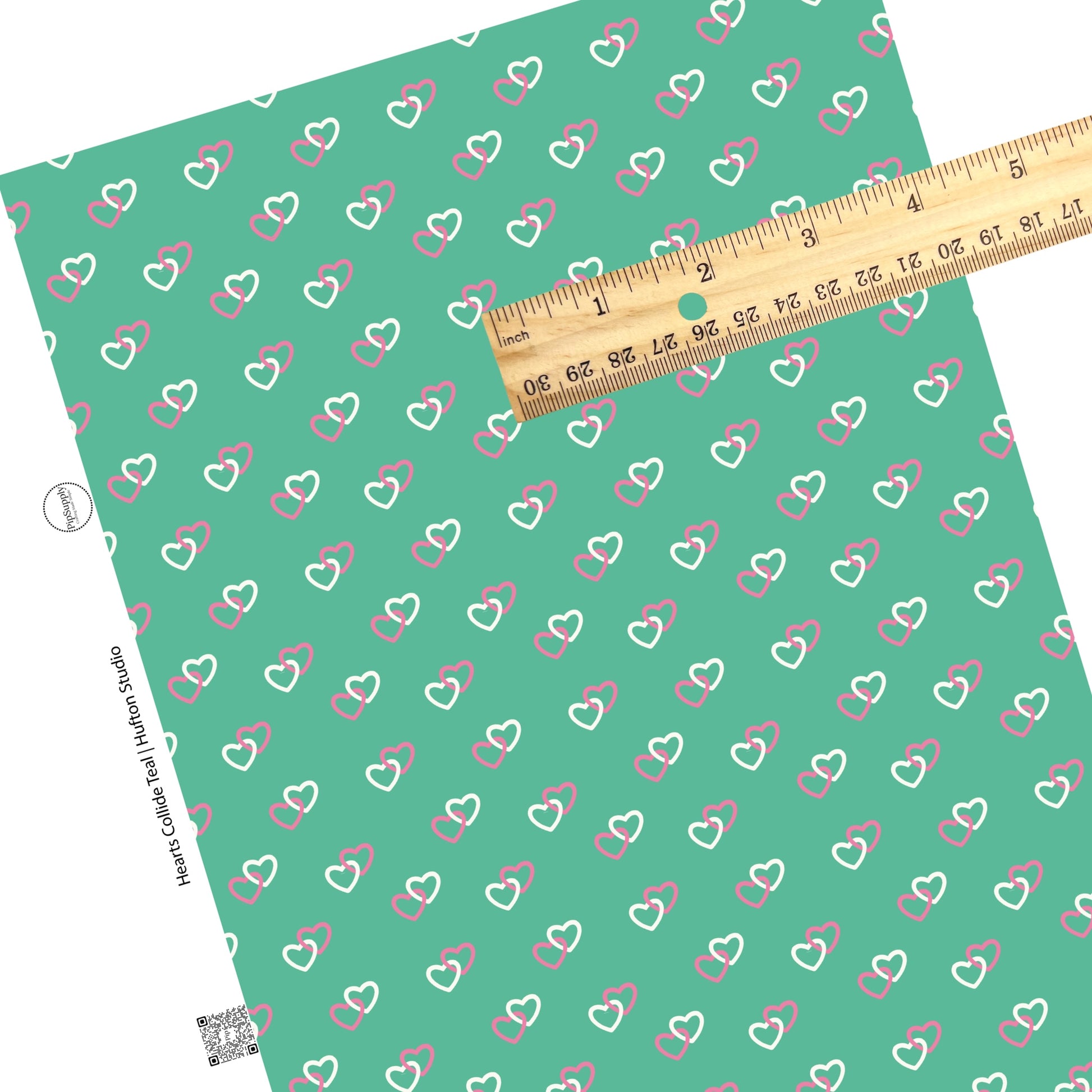 Hot pink and white hearts connected on teal green faux leather sheet