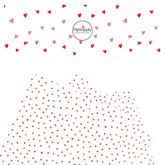 Scattered red hearts on a white faux leather sheet