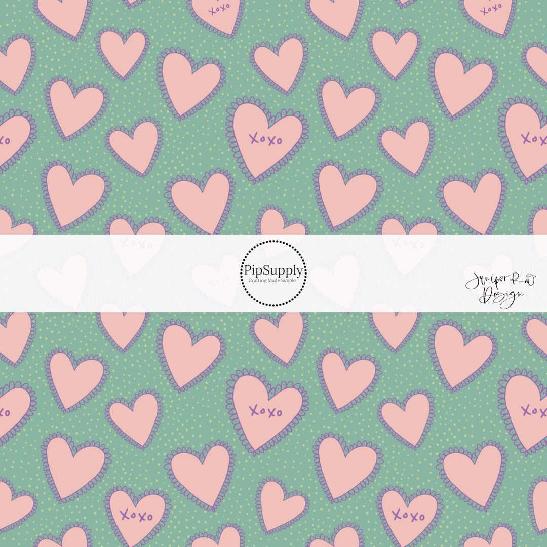 Aqua fabric by the yard with pink hearts and the words "XOXO"