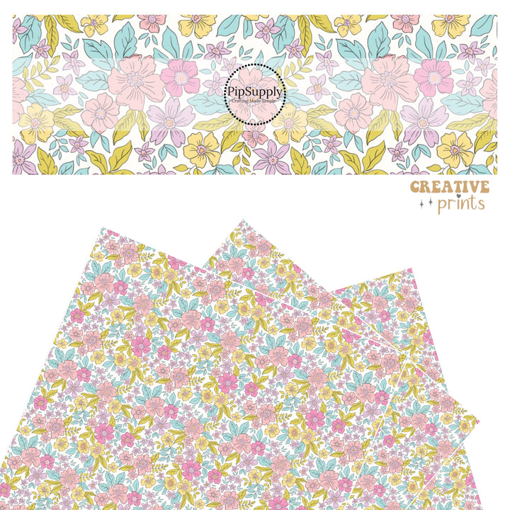 Pink, lavender, yellow, and blue flowers with blue and green leaves on white faux leather sheets