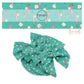 pink carrots, cream flowers, and polka dots on aqua bow strips