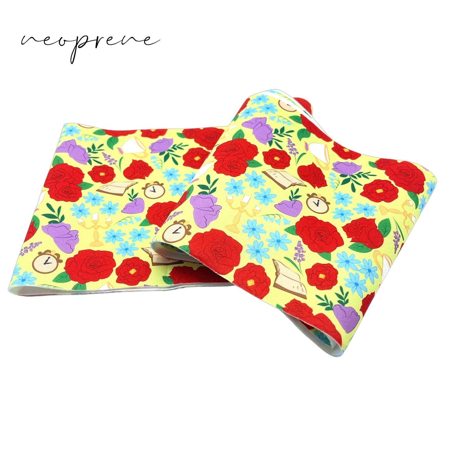 Folded pale yellow neoprene fabric with red, light blue, and purple floral princess pattern including clock face, teacups, candle sticks, and books.