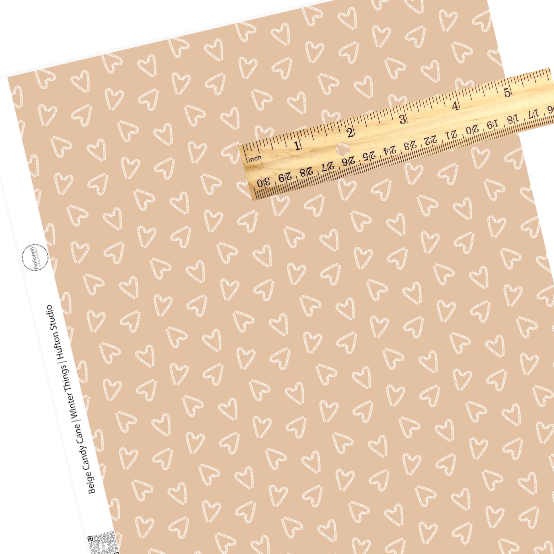 beige faux leather sheet with white heart shaped candy canes