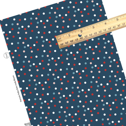 Pink, blue, white, and red polka dots on navy faux leather sheets