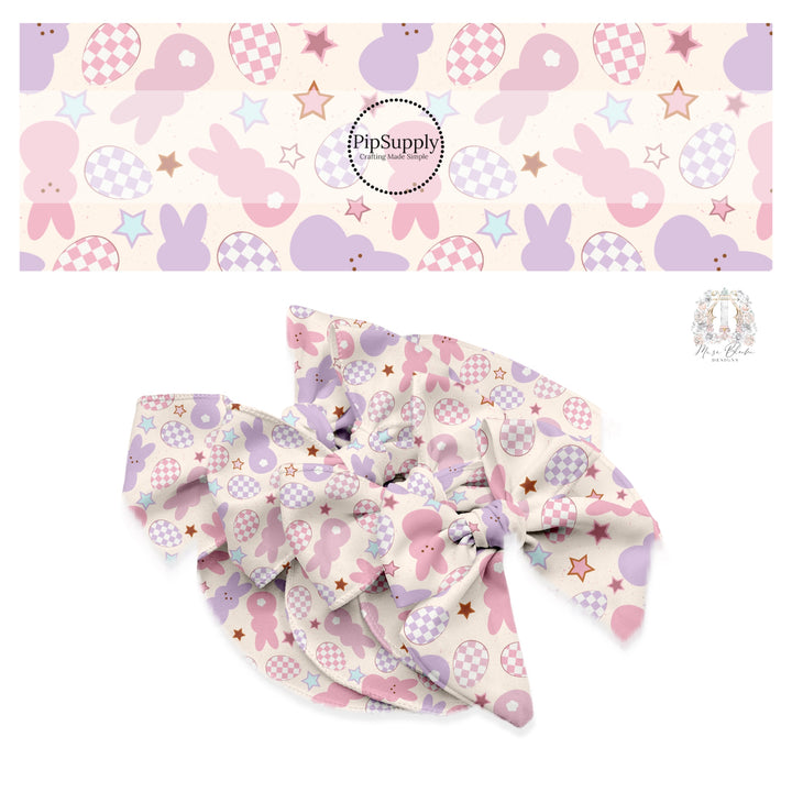 Pink and purple mallow bunnies with checkered Easter eggs and stars on cream bow strips