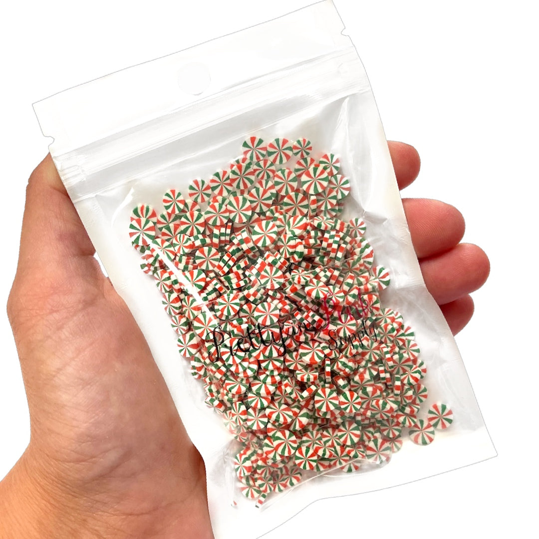 Bag of red and green swirl round peppermints polymer clay slices.