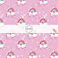 These rainbows, hearts, and stars on pink fabric by the yard features pink, mint, lavender, and red rainbows on white clouds along with tiny stars and multicolor hearts.