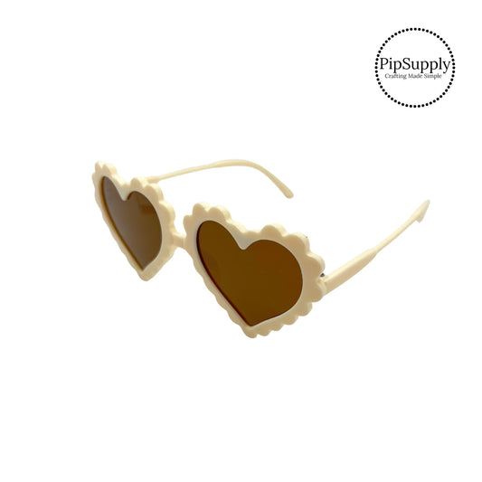 cream heart glasses with brown lenses with scalloped edges