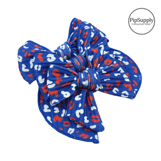 White and red leopard spots on patriotic dark blue ribbed bow strips