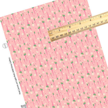 groups of pink carrots, tiny cream flowers, and polka dots on pink faux leather sheets