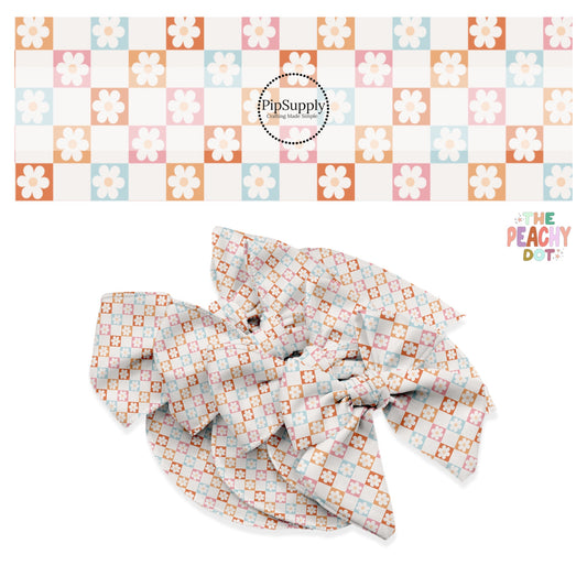 cream daisies on blue, pink, peach, and orange checkered bow strips
