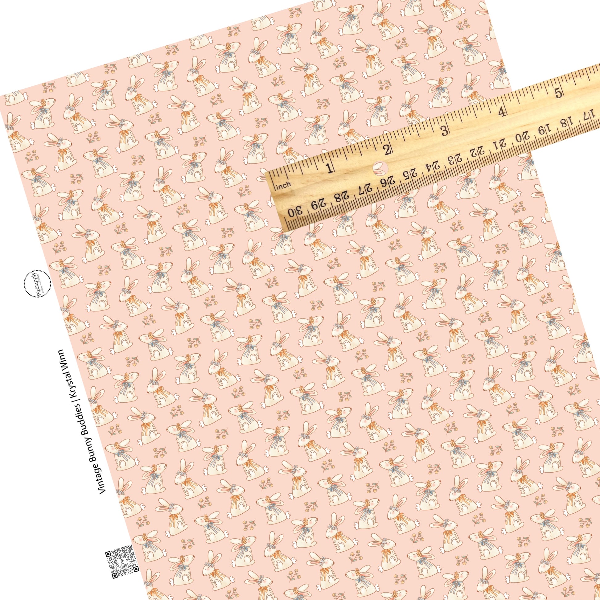 bunnies with orange and blue bow ties and floral crowns with flowers on pink faux leather sheets