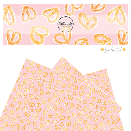 Salted heart pretzels on pink faux leather sheets