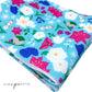 Light Blue neoprene fabric with navy, purple, white, and magenta floral princess pattern including snowman, snowflake, rocks and crystal, and cloak.