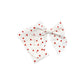 Tied and untied white Isabelle style fabric bow strip with red tiny heart pattern.
