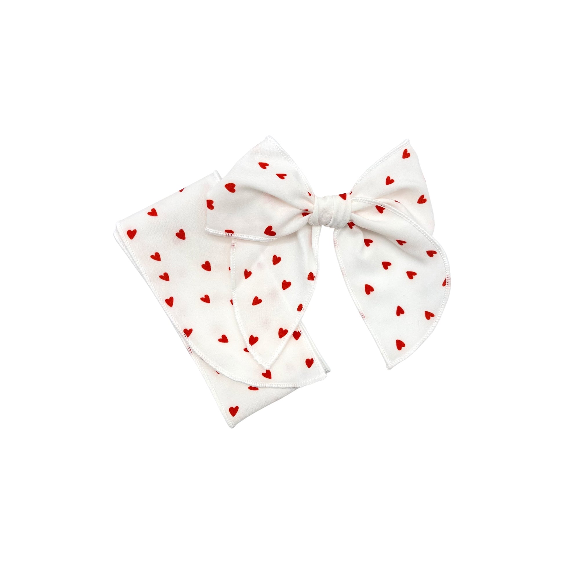 Tied and untied white Isabelle style fabric bow strip with red tiny heart pattern.