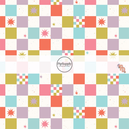 Multi-colored checker fabric with blue, coral, pink, and olive boxes and stars. 