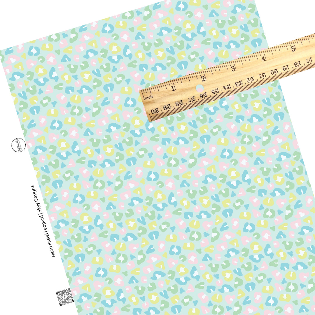 Scattered neon pastel leopard spots on mint faux leather sheets