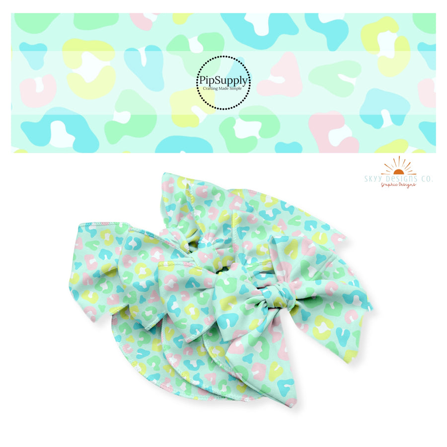 Neon pink, blue, green, and yellow leopard spots on mint bow strips