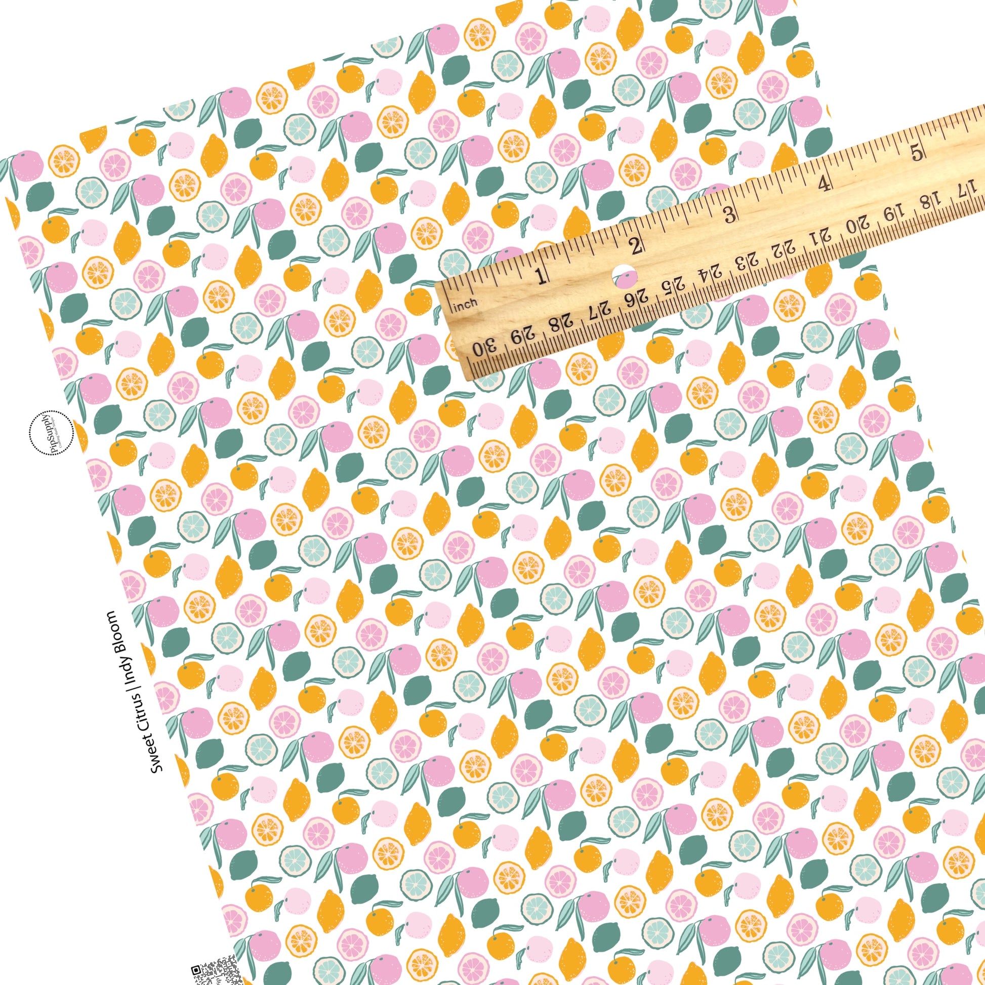 Pink, orange, and teal fruit on white faux leather sheets