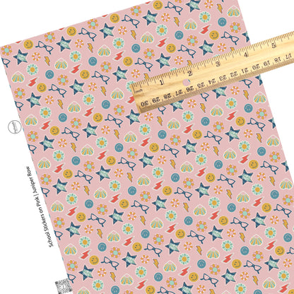 Multi colorful stickers on pink faux leather sheets