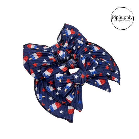 Red white and blue scattered stars and patriotic popsicles on navy blue ribbed bow strips