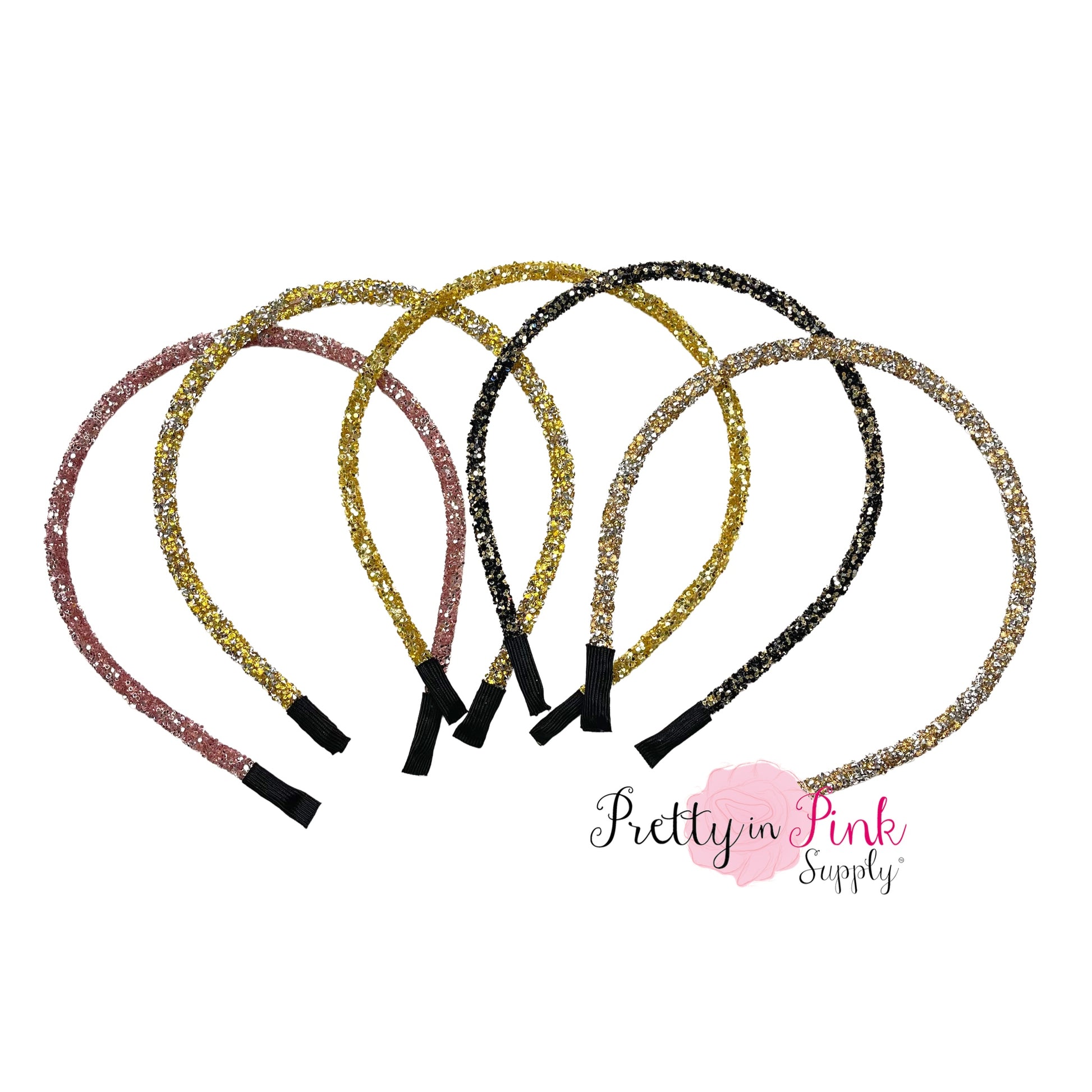 Assortment of gold, silver, and pink shiny glitter and gem lined headbands.