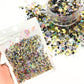 Sequin glitter mix including gold heart sequin, black star sequin, silver hollow star sequin, and rainbow holographic flakes.