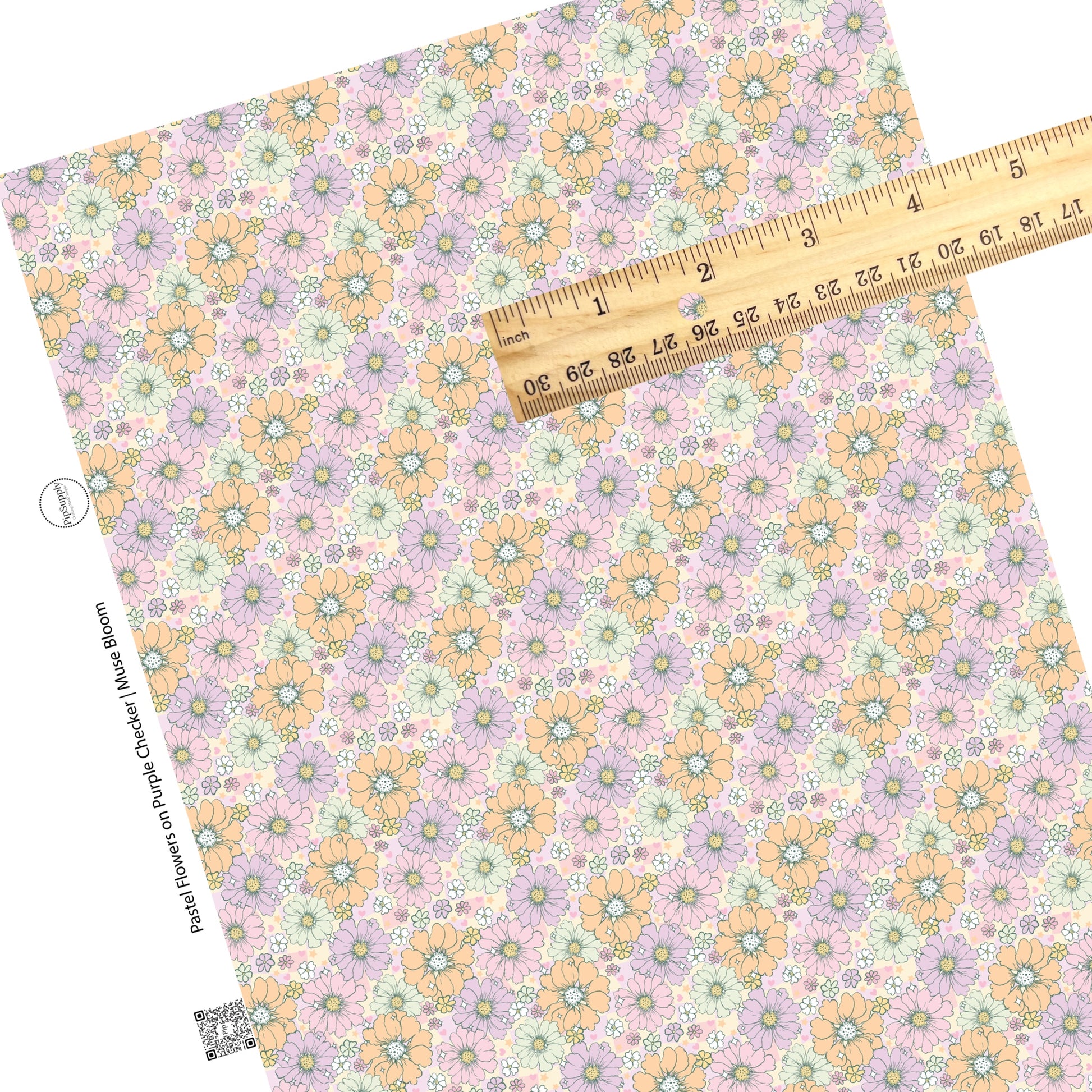 Pastel colors in pink, purple, orange, and white flowers on a purple and cream checker board pattern faux leather sheet. 