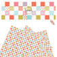 Multi checker board pattern in pink, coral, blue, and olive on a cream faux leather sheet with large and little stars. 