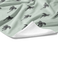 This beach towel is pistachio colored fabric with charcoal colored palm trees. 