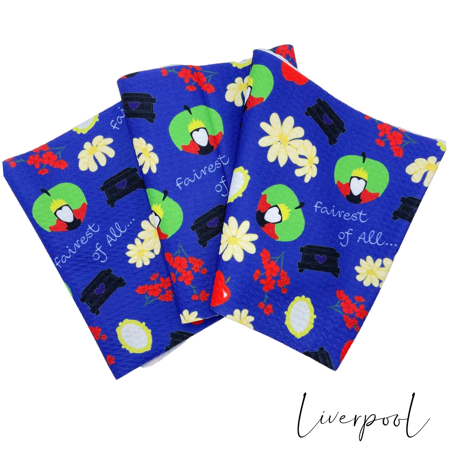 Folded royal blue Liverpool stretch fabric strip with pale yellow and red floral including the evil queen silhouette and heart chest.