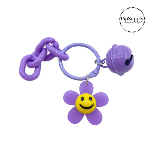 Purple flower with smiley face and purple bell and chain 